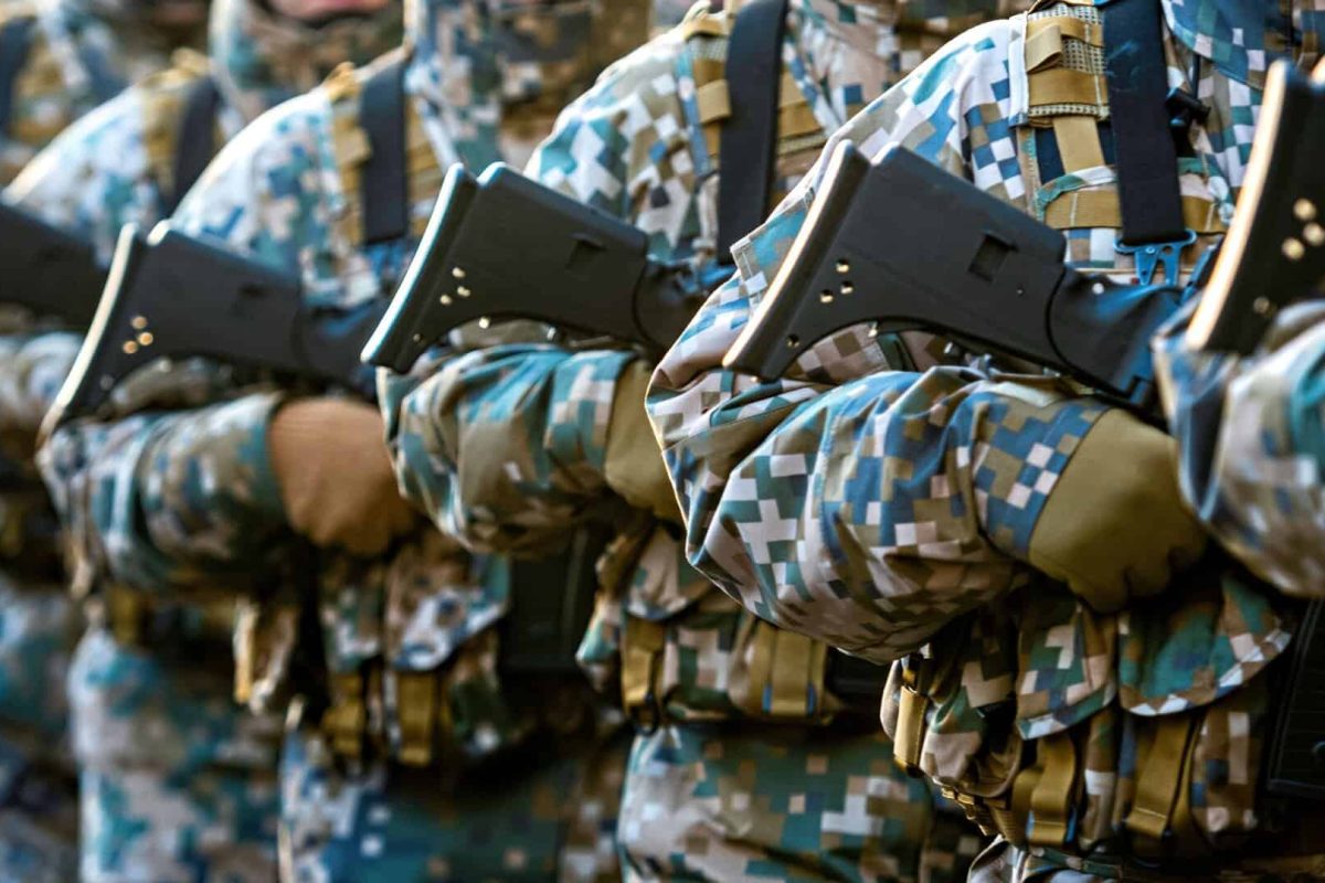 Abstract background on military theme. Soldiers with weapons, close-up, copy space - image