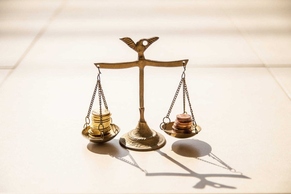 Coins on brass scales